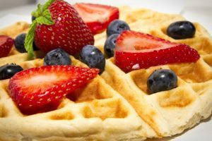waffle with strawberry and blueberry on top